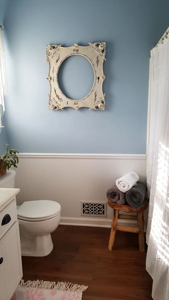 blue bathroom with white wainscotting