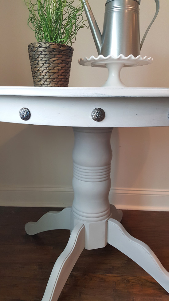 Pedestal table with nailheads