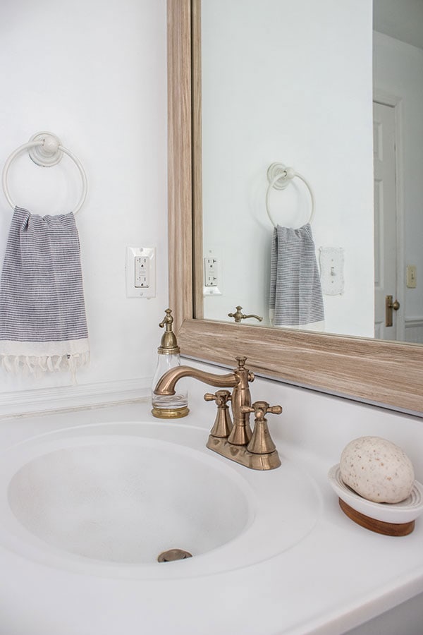 Sink area mini-makeover with brass towel bar under the sink