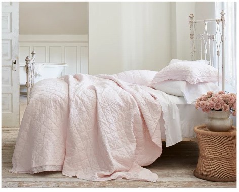 light pink quilt with crocheted trim 