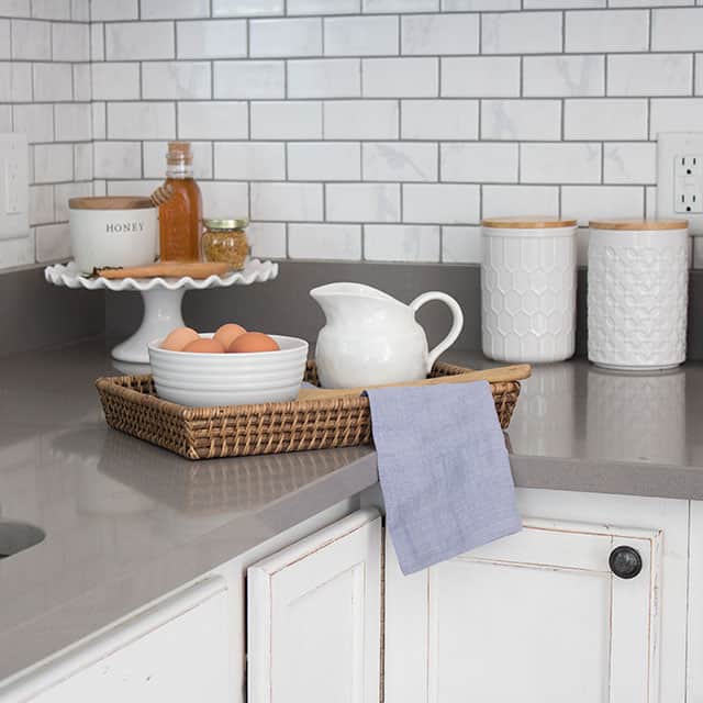 what you need to know before buying countertops - these are gray quartz counters with white cabinets