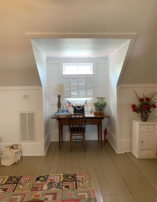 bedroom nook with desk and painted wood floors
