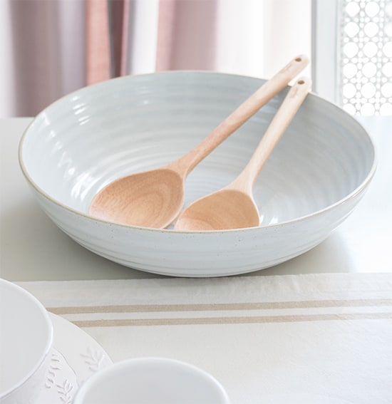 wide serving bowl for salad with wooden spoons