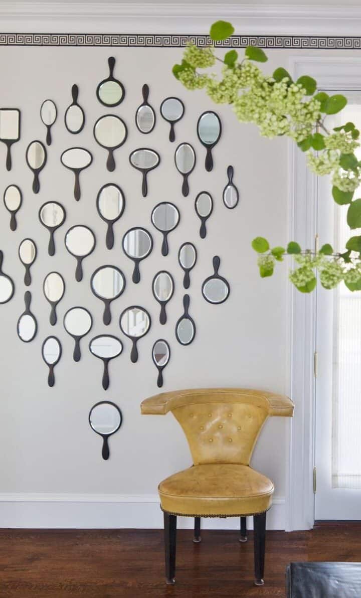 small handheld mirrors hung on wall