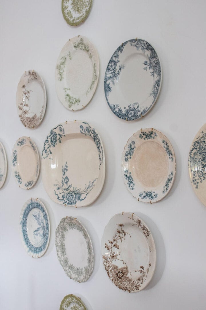 hanging dishes on wall in a grouping mix and match plates - vintage plate gallery wall