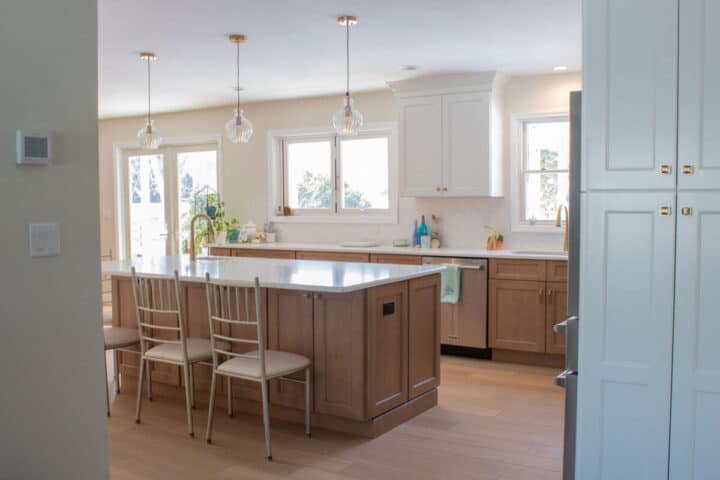 warm-wood-and-white-kitchen-with-accordian-window-to-back-deck