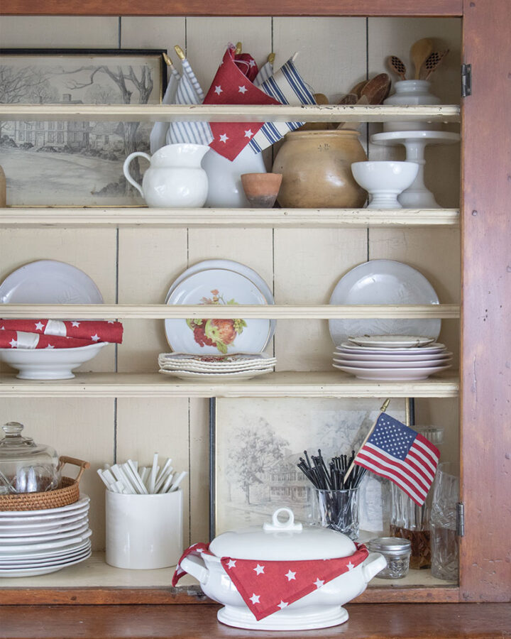 open shelves decorating for the 4th of july with red white and blue accents vintage style