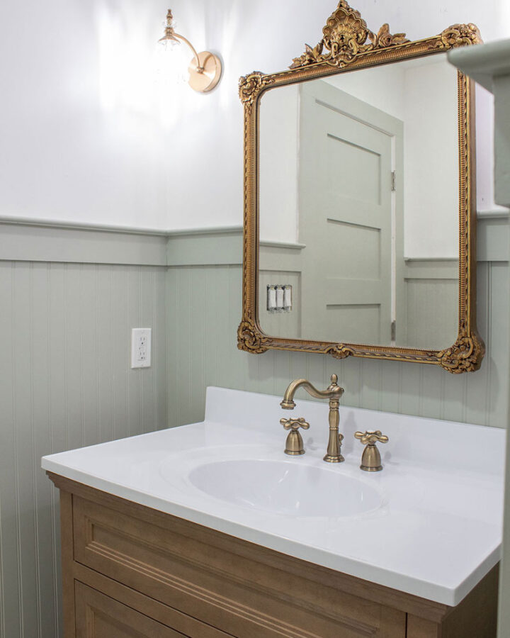 antique mirror in bathroom over vanity instead of medicine cabinet - how to add historic charm to a home renovation
